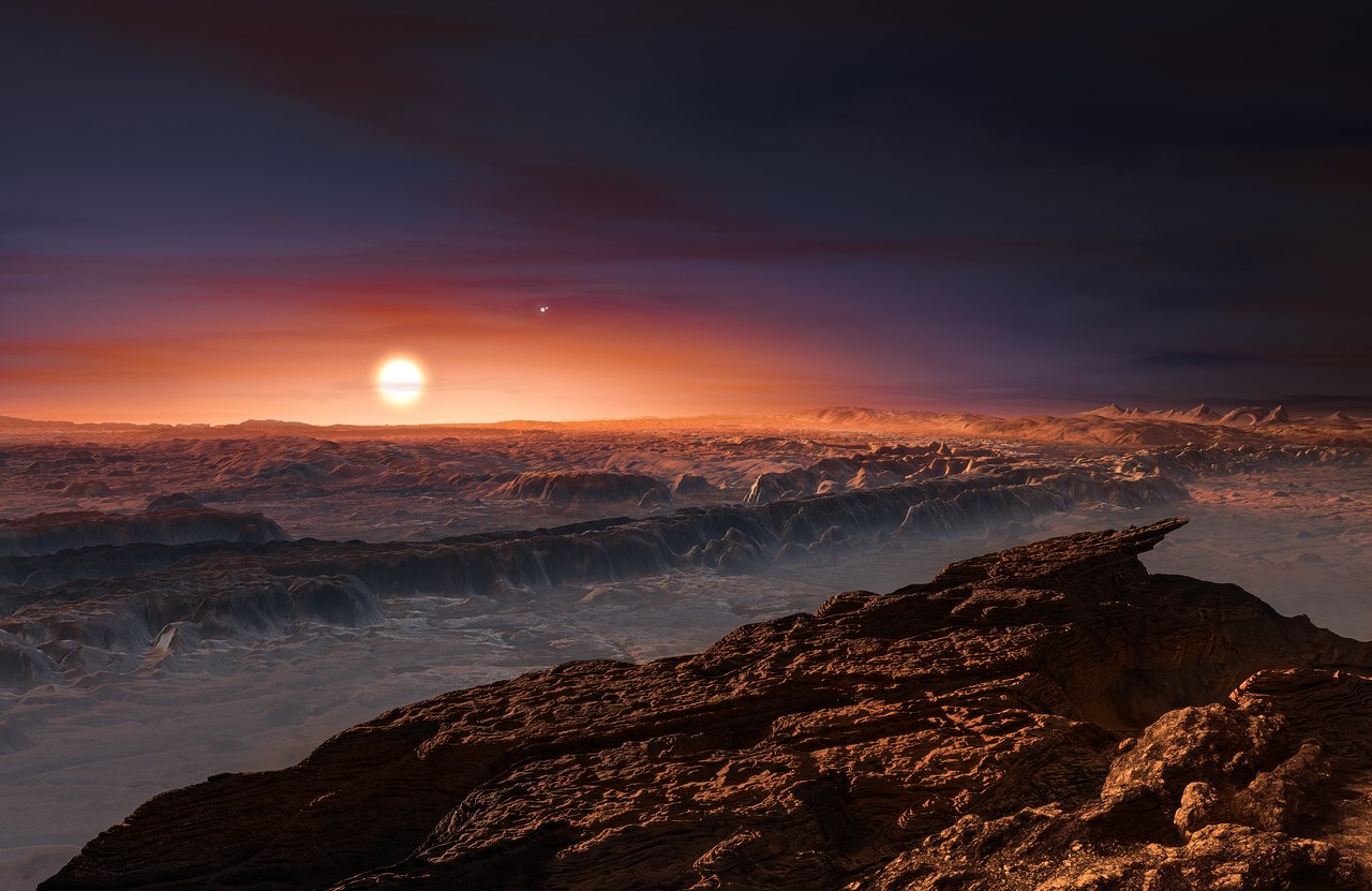 This artist’s impression shows a view of the surface of the planet Proxima b orbiting the red dwarf star Proxima Centauri, the closest star to the Solar System. The double star Alpha Centauri AB also appears in the image to the upper-right of Proxima itself. Proxima b is a little more massive than the Earth and orbits in the habitable zone around Proxima Centauri, where the temperature is suitable for liquid water to exist on its surface.